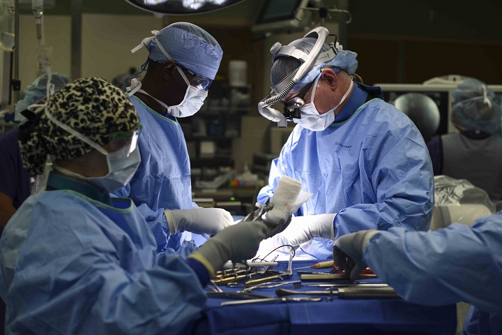 Air Force Col. (Dr.) Edward Anderson, 99th Medical Group orthopedic spine surgeon, performs a lumbar microdiscectomy surgery at Nellis Air Force Base, Nevada. A lumbar microdiscectomy surgery is performed to remove a portion of a herniated disc in the lower back. (U.S. Air Force photo by Airman 1st Class Andrew D. Sarver)