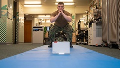 Hospital Corpsman Conor Tucker from the Naval Medical Center Portsmouth's physical therapy department demonstrates physical therapy moves