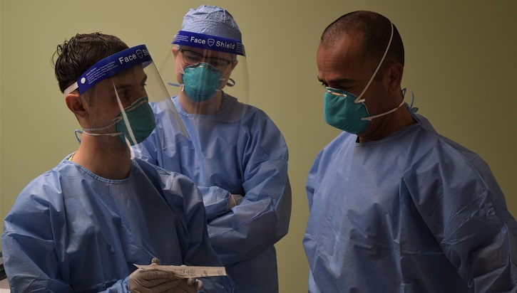 Three healthcare workers wearing masks