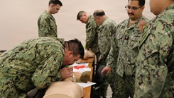 Sailors peforming CPR during a training session