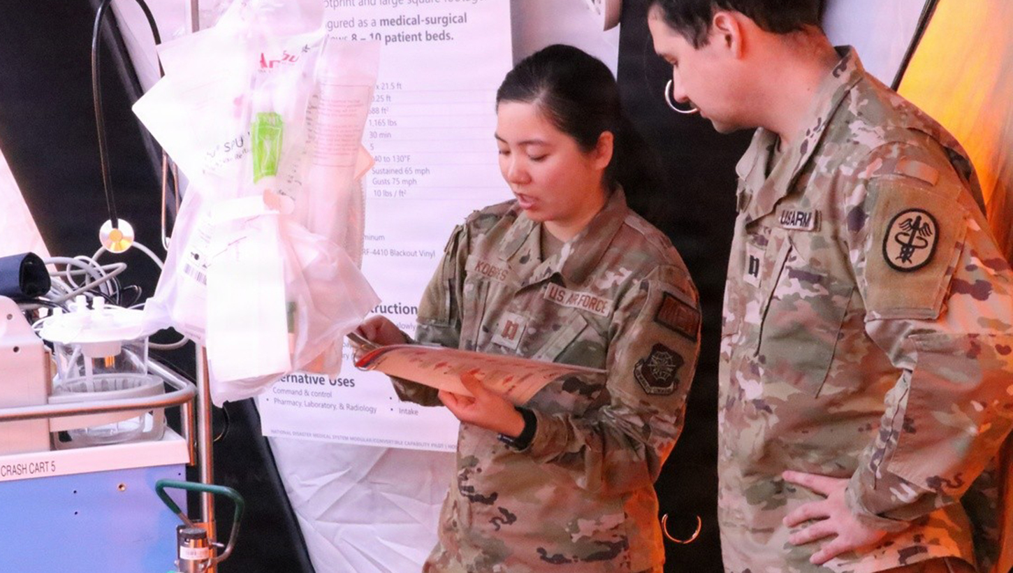U.S. Air Force Capt. Pei-Ying Kobres, University of California, Davis, emergency resident physician, left, and U.S. Army Capt. Colin Rose, Brooke Army Medical Center resident physician, review the contents of a crash cart