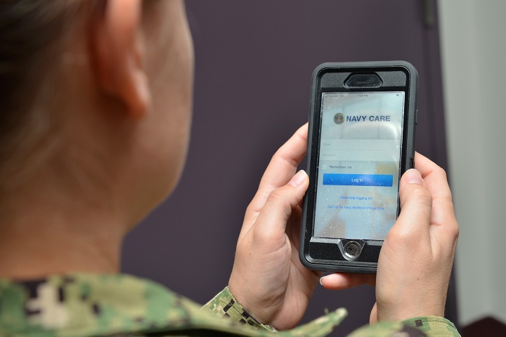 A Sailor uses the Navy Care app on her cell phone for a virtual health visit with a Naval Hospital Jacksonville provider. Navy Care enables patients to have a live video visit with a clinician on a smartphone, tablet, or computer. It’s private, secure, and free. (U.S. Navy photo by Petty Officer 1st Class Jacob Sippel)