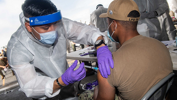 Image of Military health personnel giving the COVID-19 Vaccine to military personnel. Click to open a larger version of the image.