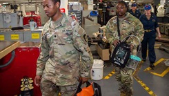 U.S. Army Spc. Michael Kiarie, left, and U.S. Army Sgt. Jaliah Rudolph, from the 62nd Medical Brigade, transport medical equipment during joint tactical combat casualty care training between soldiers and sailors aboard USS Ronald Reagan in the U.S. 3rd Fleet area of operations. The mission was to provide medical training to learn from the ship’s medical department and share knowledge across branches. (Photo by U.S. Navy Petty Officer 2nd Class Eric Stanton)