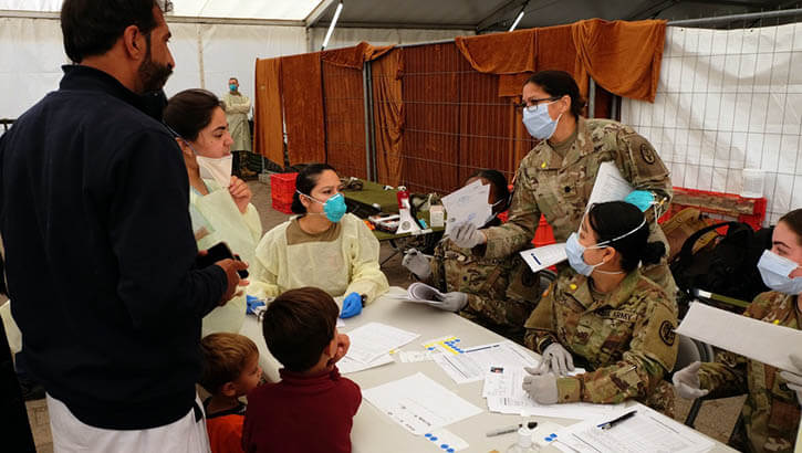 Medical personnel check in Afghan evacuees waiting to receive measles, mumps and rubella and chickenpox vaccines.