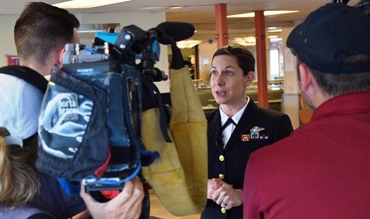 Navy Lt. Cmdr. Erika Schilling, a nurse midwife at Naval Hospital Bremerton, Washington, is interviewed by radio and television reporters in Seattle, Jan. 18, 2018. Shilling was recognized by Washington State Ferries with the Life Ring Award certificate for her life saving efforts on Dec. 2, 2017, when she saved a male passenger's life by administering emergency cardiopulmonary resuscitation for 14 minutes on the Kingston-Edmunds ferry. (U.S. Navy photo by Douglas Stutz)
