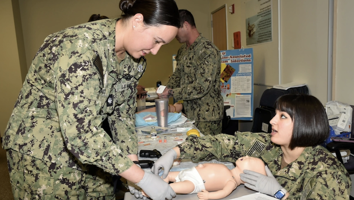 Competence clarified at Naval Hospital Bremerton…Cmdr. Krystal Chunaco, NHB Directorate of Surgical Services clinic manager receives refresher training on intraosseous devices from Lt. Barbara Kent, NHB Pediatrics Clinic department head, who was also the lead coordinator of the multi-disciplinary and collaborative Nurse Corps Skills Sustainment Fair – billed as a nursing fair for nurses by nurses - held over a two-day period in mid-January 2024. (Photo: Douglas H Stutz)