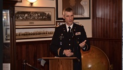 Military personnel speaking at a podium