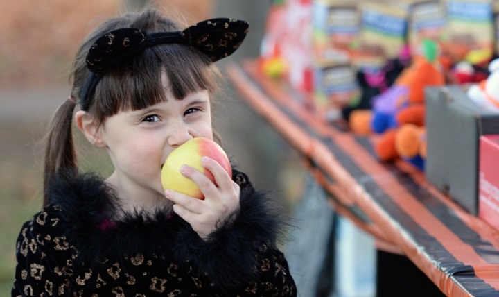 A child eats an apple during a Trunk-or-Treat event, which featured a healthy snack station as an alternative to candy, at Ramstein Air Base, Germany. (U.S. Air Force photo by Senior Airman Jimmie D. Pike)