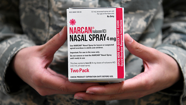 Image of Airman holding Narcan, a brand of naloxone.