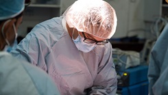 Military surgeon performs surgery