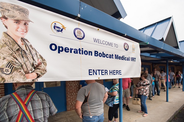 Area residents line up outside Lee County High School in Beattyville, Kentucky to receive treatment at a health-care clinic being operated by the Air National Guard and U.S. Navy Reserve. The clinic is one of four that comprised Operation Bobcat, a 10-day mission to provide military medical troops with crucial training in field operations and logistics while offering no-cost health care to the residents of Eastern Kentucky. (U.S. Air Force photo by Lt. Col. Dale Greer)