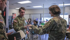 military personnel demos a strength training machine