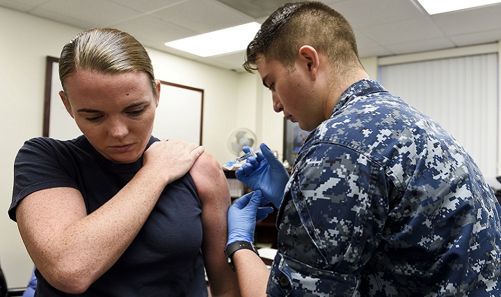 Given its nature and the potential for pandemics, flu is of particular concern regarding Force Health Protection and global health. Navy Petty Officer 3rd Class Esteven Baca, from the immunizations department at Naval Hospital Pensacola, administers a flu shot to Lt. Alison Malloy, Staff Judge Advocate for the Center for Information Warfare Training. (U.S. Navy photo by Petty Officer 3rd Class Taylor L. Jackson)