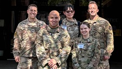 Maj. Anthony Niederriter (top left) and Maj. Matthew Waller (top right), both 911th Aeromedical Staging Squadron mental health nurses, pose for a photo with their behavioral health team