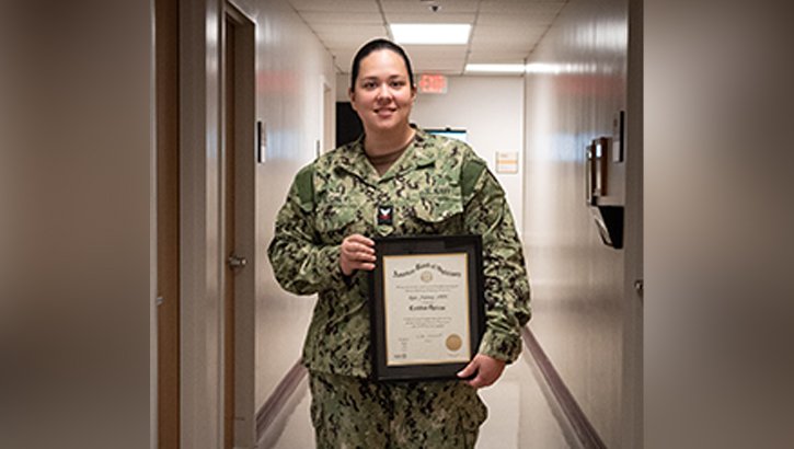 U.S. Navy Hospital Corpsman Second Class Rylie Maloney holds her optician's license