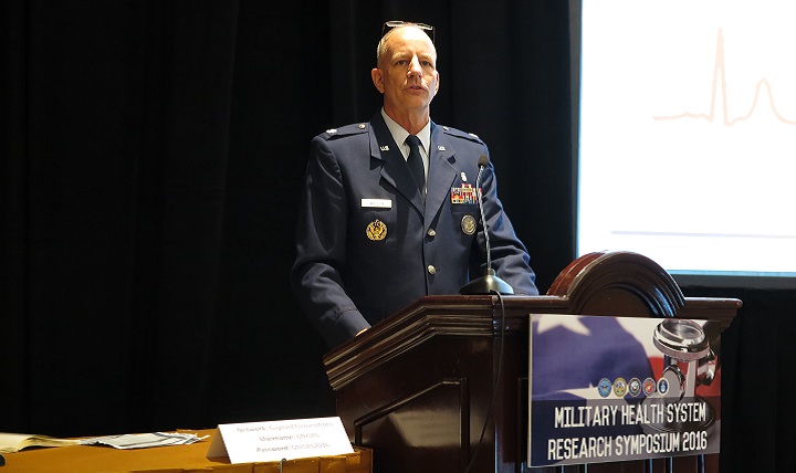 Air Force Lt. Col. David Watson discusses the outcomes of the Air Force Medical Service Personalized Medicine Clinical Utility Study with researchers at the MHS Research Symposium.