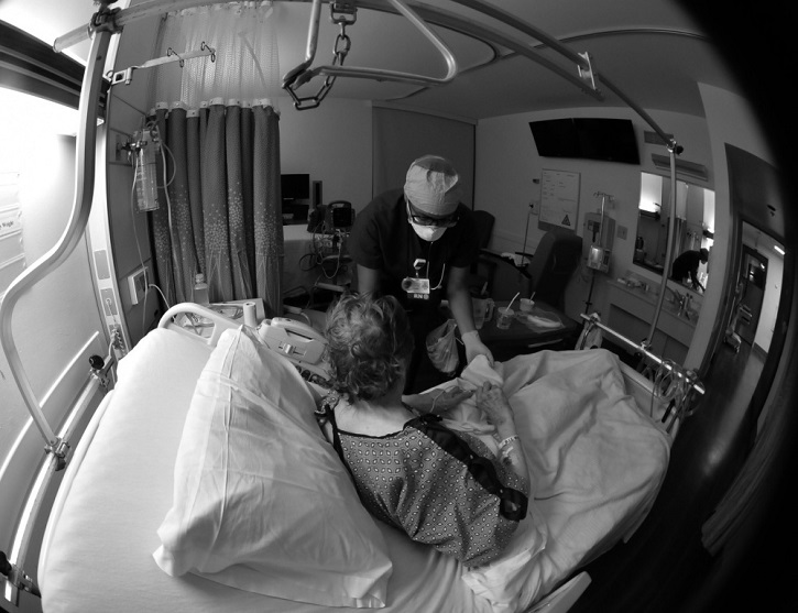 Image of Military health personnel taking care of a patient. Click to open a larger version of the image.