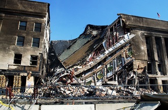 Link to Photo: A section of the Pentagon lies in ruins following the deadly Sep. 11 terrorist attack in which a hijacked commercial airliner was crashed into the Pentagon. American Airlines FLT 77 was bound for Los Angeles from Washington Dulles with 58 passengers and 6 crew. All aboard the aircraft were killed, along with 125 people in the Pentagon. (U. S. Naval photo by Photographer's Mate 1st Class Michael W. Pendergrass)