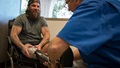Retired U.S. Army Sgt. Derek Weida jokes with a physician during his prosthetic leg fitting at a prosthetics clinic in Las Vegas in April 2018. 