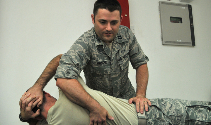 Air Force Capt. Jared Bueche, physical therapist, works with a patient. Eligible Airmen interested in biomedical sciences education or commissioning opportunities can now apply for any of the four available Biomedical Sciences Corps programs now accepting applications, including physical therapy. (U.S. Air Force photo by Senior Master Sgt. Eric Peterson)
