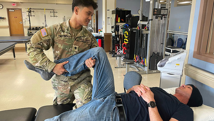 U.S. Army Spc. Joelle Pamplona, physical therapy specialist, provides joint mobilization treatment on a patient at Madigan Army Medical Center on Joint Base Lewis-McChord, Washington. Pamplona helps veterans, soldiers and their families recover from various injuries. (Courtesy Photo)