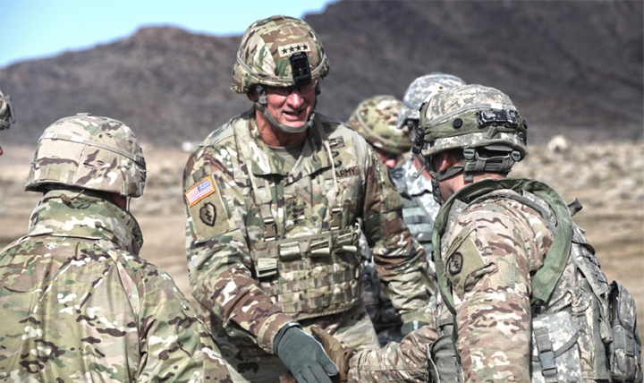 A career spent in the infantry coupled with an active lifestyle led to 12 knee surgeries for U.S. Army Gen. Robert B. Brown, Commanding General of U.S. Army Pacific. Shown here (center) greeting soldiers at the National Training Center Fort Irwin, Calif., Brown credits an effective physical therapy regimen for getting him back in the field. (U.S. Army Sgt. Michael Spandau)