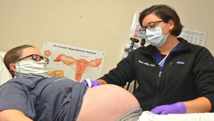 Image of Photo of a medical provider checking out a pregnant woman. Click to open a larger version of the image.