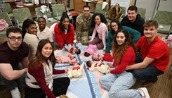 Parents pose for photo at Centering Pregnancy Program Reunion