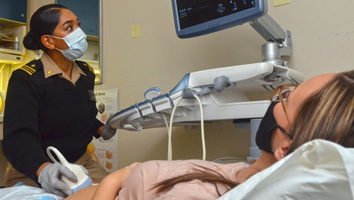 Image of A certified nurse midwife performs an ultrasound on a patient. Click to open a larger version of the image.