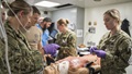 Military personnel performing emergency surgery
