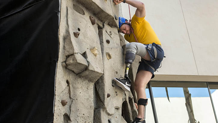 Navy Seaman Chris Krobath, a prosthetics patient at Naval Medical Center San Diego, reached for new heights on the hospital’s climbing wall as part of rehabilitation therapy. 
