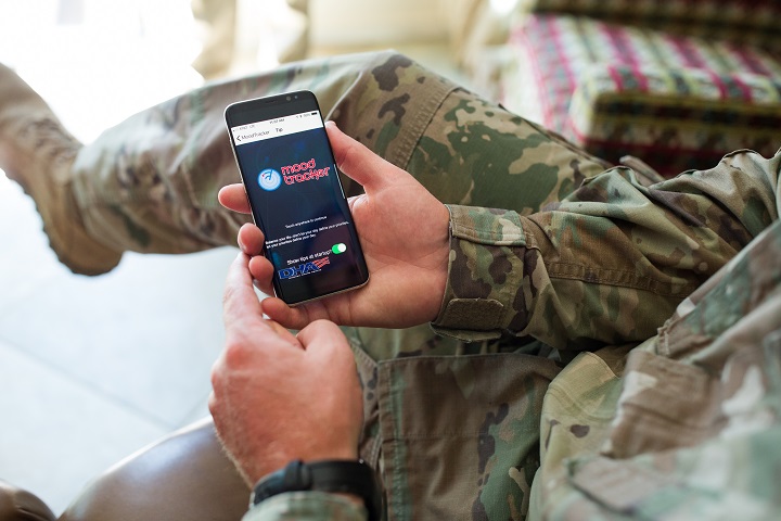An Army health care provider loads the T2 Mood Tracker mobile app on a mobile device for a demonstration for his patients. (DoD photo)