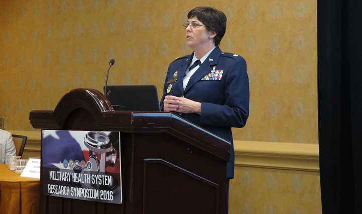 Speaking to medical researchers on Aug. 15, 2016 at the MHS Research Symposium, Air Force Lt. Col. Brandi Ritter (standing) and Air Force Lt. Col. Imelda Catalasan (not pictured) discussed optimization of the electronic institutional review board. They encouraged feedback from users to promote collaborative solutions.