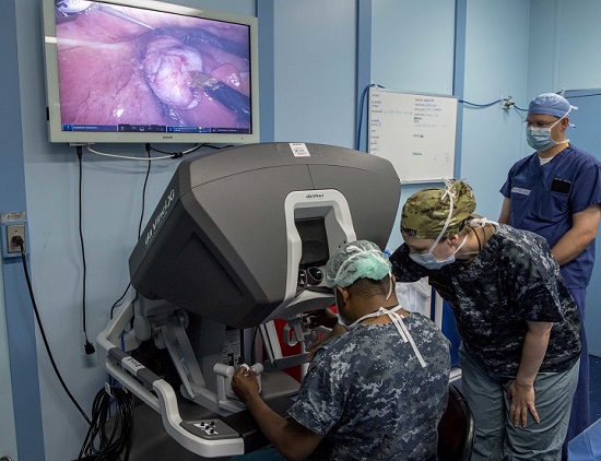 Navy Cmdr. Tamara Worlton (right), a surgeon assigned to Military Sealift Command hospital ship USNS Mercy for Pacific Partnership 2018 and Dr. Vyramuthu Varanitharan (left), a Sri Lankan general surgeon at Base Hospital Mutur, Sri Lankan from Base Hospital Mutur, discuss robotic surgery techniques during the first robot-assisted surgery on a patient while aboard the Mercy using the Da Vinci XI Robot Surgical System. (U.S. Navy photo by Mass Communication Specialist 2nd Class Kelsey L. Adams)