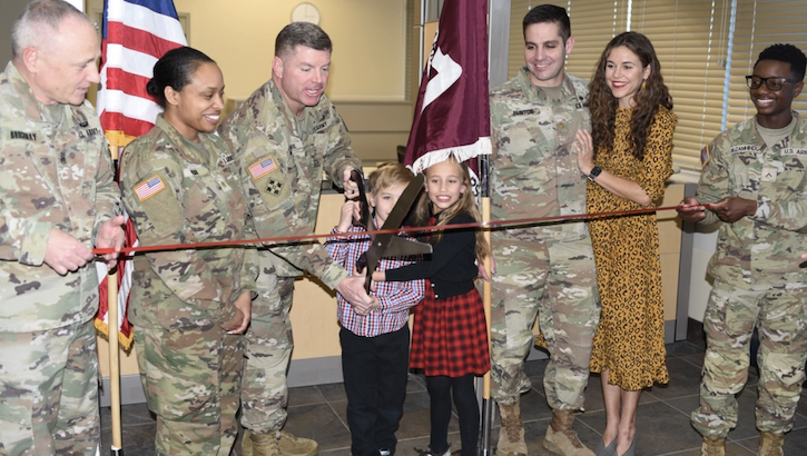 Col. Edward Mandril, Evans Army Community Hospital commander/director, cuts the ribbon to officially welcome the hospital’s Child, Family and School Based Behavioral Health program's return to the main hospital campus with a ribbon-cutting ceremony March 4. Assisting Mandril, were the children of Maj. (Dr.) Christopher Flinton, the Chief of the CAFBHS. Also pictured are Command Sgt. Maj. Jeremy Brockway, EACH CSM, and Maj. Cassandra Webb, from the EACH Behavioral Health Department, and Flinton's spouse. (Photo: Gino Mattorano)