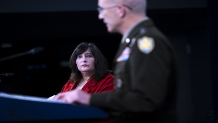 Image of Military personnel talking at a podium. Click to open a larger version of the image.