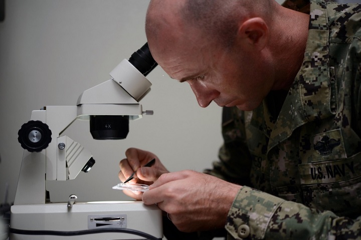 U.S. Navy Petty Officer 1st Class James Bowes, senior preventive-medicine technician, places mosquitoes on a dish to view under a microscope. Project Sea Raven’s capabilities are not limited to just insects – it can test anything from blood to soil and water. (U.S. Navy photo by Petty Officer 1st Class Tom Ouellette)
