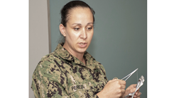 Corpsman demonstrates suturing techniques to class