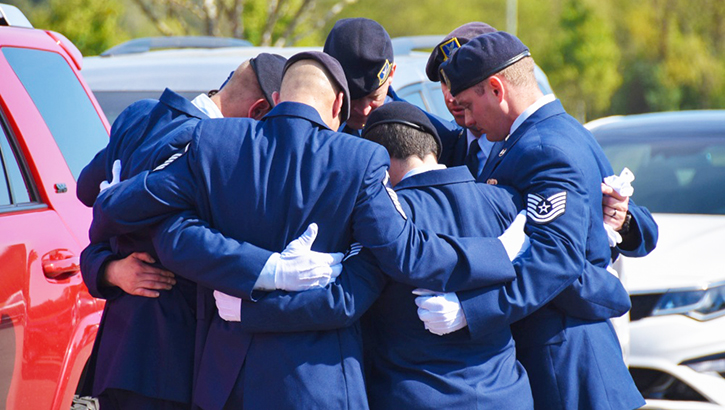 Image of Group of airmen hugging each other. Click to open a larger version of the image.