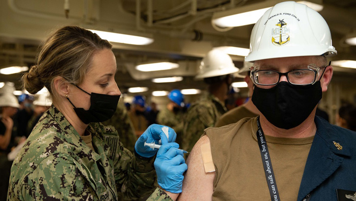 Military health personnel administering the flu shot