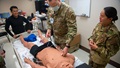 Military medical personnel training on CAE apollo mannequin