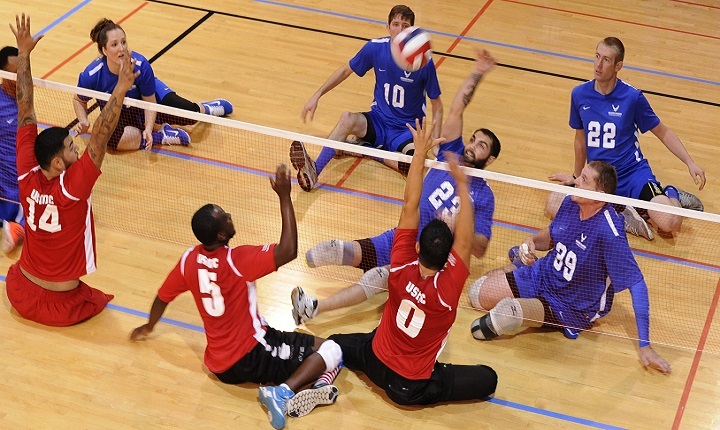 A member of the Air Force wounded warrior volleyball team spikes the ball during a volleyball match as part of the Warrior Care Month Sitting Volleyball Tournament at the Pentagon.