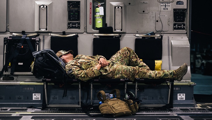 An Air Force Airman sleeps inside a C-17 Globemaster III during a flight over an undisclosed location in support of Operation Freedom Sentinel. (U.S. Air Force photo illustration)