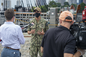 Military personnel being interviewed while wearing a mask