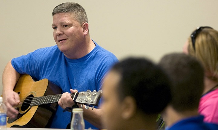 Former Air Force Maj. Frank Vassar plays one of his songs to fellow wounded Airmen during a music therapy session on Joint Base Andrews, Md., as part of Warrior Care Month.