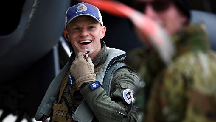 Image of Military personnel laughing. Click to open a larger version of the image.