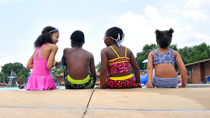 Image of Children sitting by the pool.