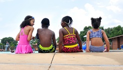 Children sitting by the pool