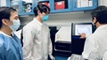 Dr. Keith Fong reviews data with other lab technicians